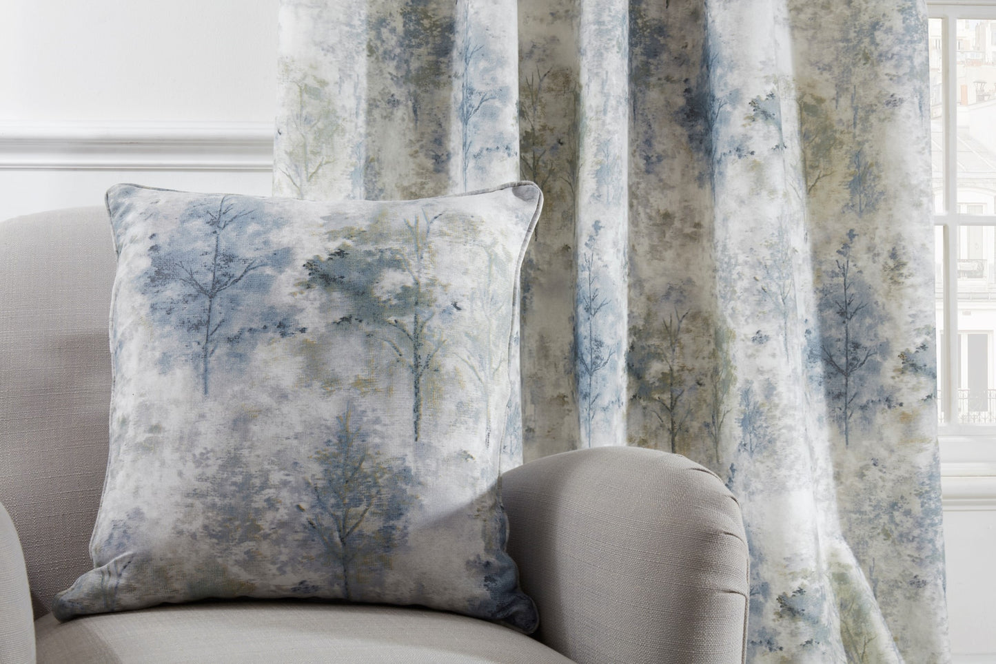 A beautiful woodland watercolour cushion with blue, green and grey colouring with a polyester cushion pad. Matching curtains available.